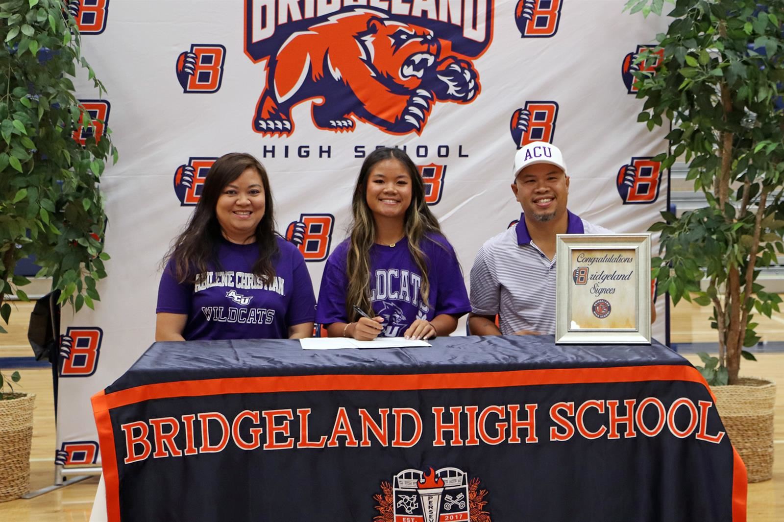 Bridgeland High School senior Jasmine Do, seated center, signed a letter of intent to Abilene Christian University.